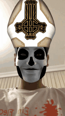 a man wearing a skull mask and a bishop hat