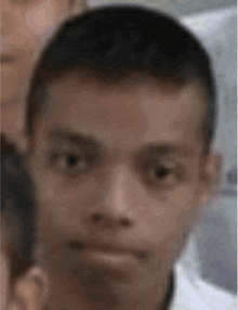 a close up of a man 's face with a serious look on his face