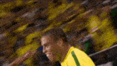 a blurry picture of a soccer player wearing a yellow shirt