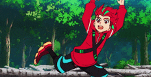 a boy with red hair is jumping in the air in a forest