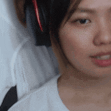 a close up of a woman 's face with headphones on her head .