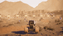 a monster truck is driving down a dirt road