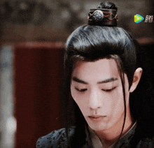 a man with a crown on his head is looking down at something