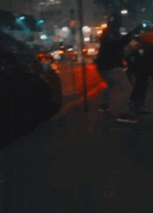a blurry picture of a person standing in front of a street sign