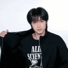 a man wearing a black shirt that says all scien