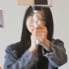 a woman is taking a picture with a cell phone .