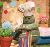 a stuffed animal with a chef 's hat and apron