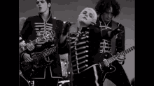 a black and white photo of a band playing a concert .