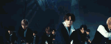 a group of young men are dancing on a stage