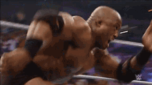 a blurry picture of a person wrestling in a ring with a w logo in the background .