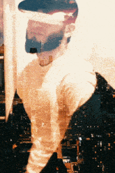 a double exposure of a man with a city skyline in the background