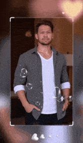 a man with his hands in his pockets is surrounded by bubbles