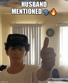 a young man wearing a hat gives a thumbs up with a caption that says husband mentioned