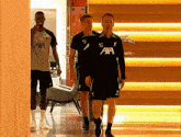 a man wearing a aaa jersey walks with another man