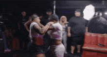 a group of people are dancing in a room with a red couch and a sign that says zeus