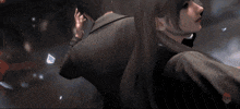 a close up of a man holding another man 's hand .