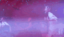 a purple and red background with a person standing in the foreground