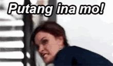 a woman is making a funny face with the words puting ina mo !