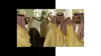 a group of men in traditional arabic clothing are standing next to each other in a room .