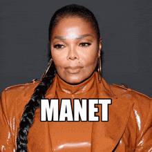a woman wearing a brown leather jacket with the name manet on it