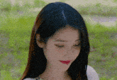 a close up of a woman 's face with her eyes closed and red lipstick