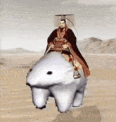 a man in a costume is riding a polar bear in the desert .