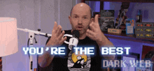 a man in front of a microphone with the words you 're the best dark web behind him