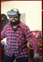 a man wearing a virtual reality headset is dancing