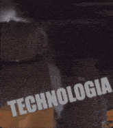 a man holding a sign that says " technologia "