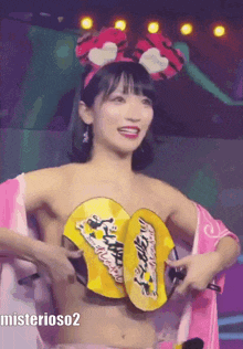 a woman without a shirt is holding a fan in front of her chest and the caption mysterioso2