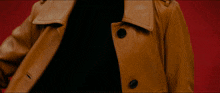 a close up of a person wearing a brown leather coat