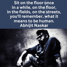 a black and white photo of a man with a quote by abhijit naskar on the bottom