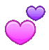 two pink and purple hearts are floating in the air .