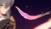 a close up of a person holding a pink feather in a dark room .