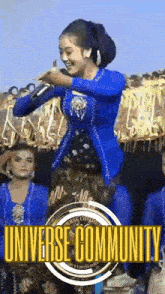 a woman in a blue dress is singing into a microphone in front of a crowd of people .
