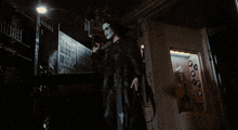 a person in a black jacket is holding a knife in their hand