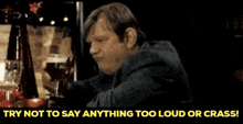 a man is drinking a glass of beer with the words try not to say anything too loud or crass below him
