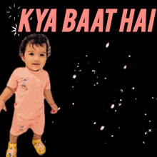 a baby is holding a bouquet of flowers with the words " kya baat hai super " above him