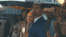 a man in a suit is holding an umbrella in the rain with a big bold beautiful journey written above him