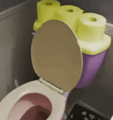 a toilet with two rolls of toilet paper on top of it