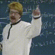 a man is standing in front of a blackboard with numbers on it .
