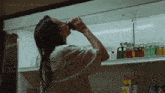 a woman drinking from a bottle in front of a refrigerator with the website p3ns1v3.tumblr.com visible