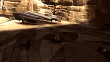 a space ship is sitting on the ground in front of a wall