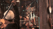 a man in a white hat is holding a pole in a crowded room