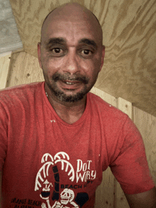 a man wearing a red shirt that says dot why