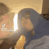 a tiktok video of a woman covering her face