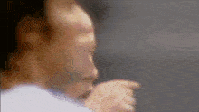 a blurry picture of a man 's face with a microphone in his hand
