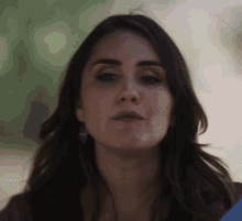 a close up of a woman 's face with her eyes closed