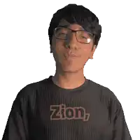 a man wearing glasses and a black zion shirt