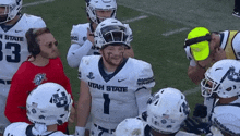 a group of utah state football players standing on a field